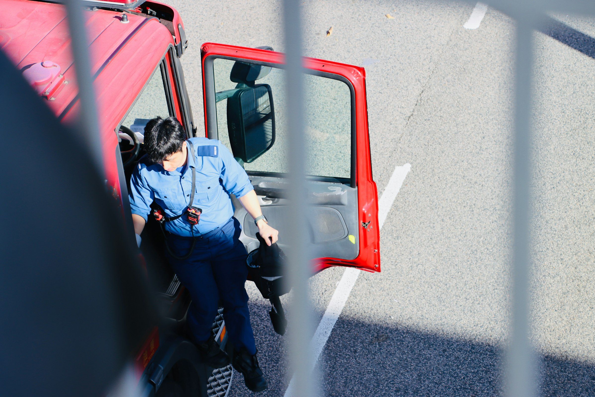 Driver stepping out of a red truck
