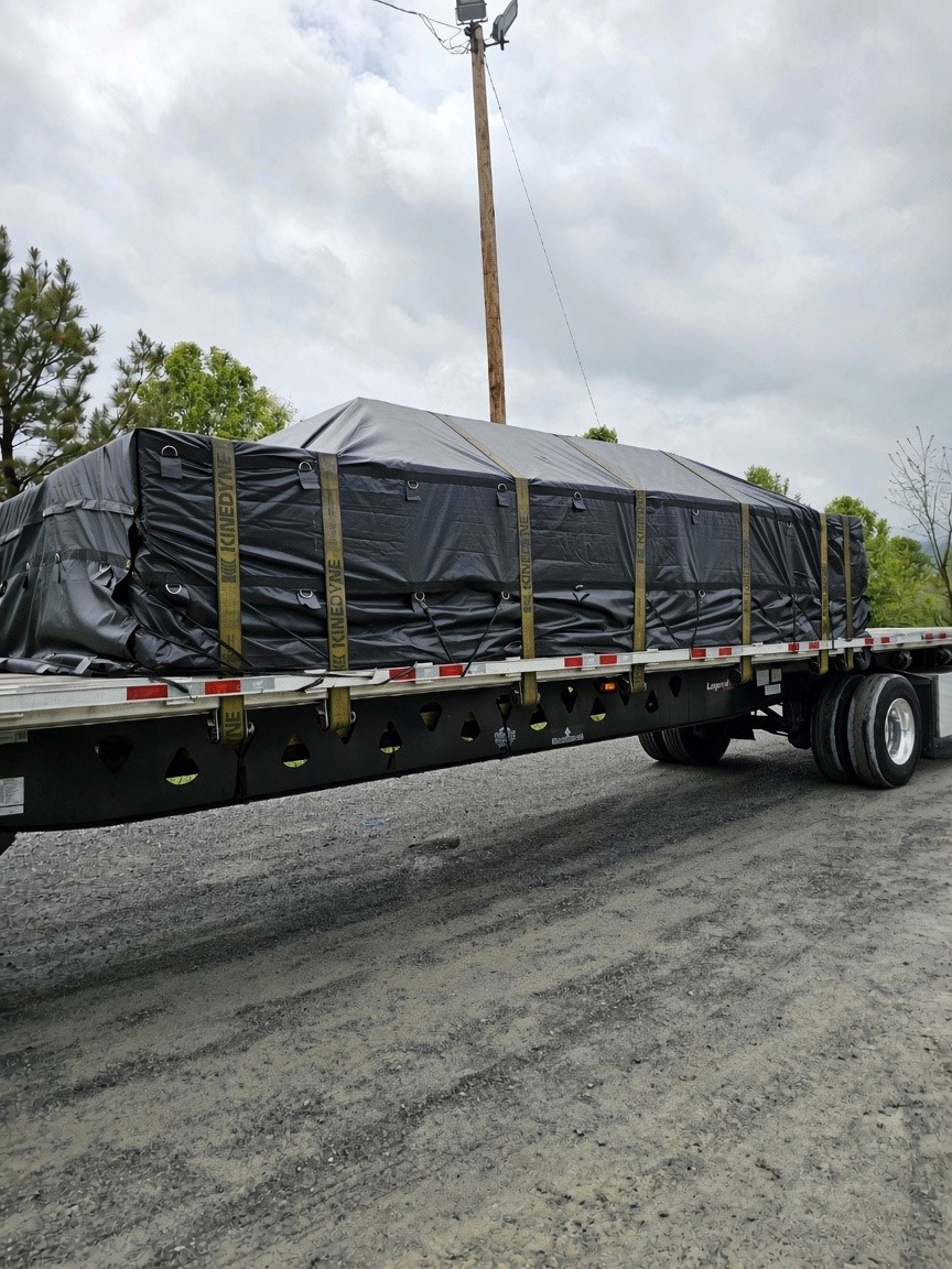 Tarped flatbed load locked for transit