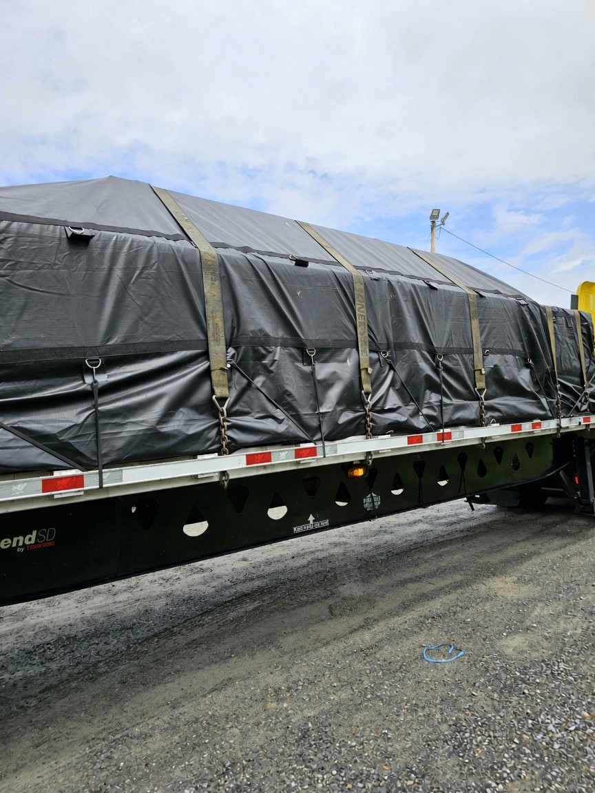 Tarped flatbed load locked for transit