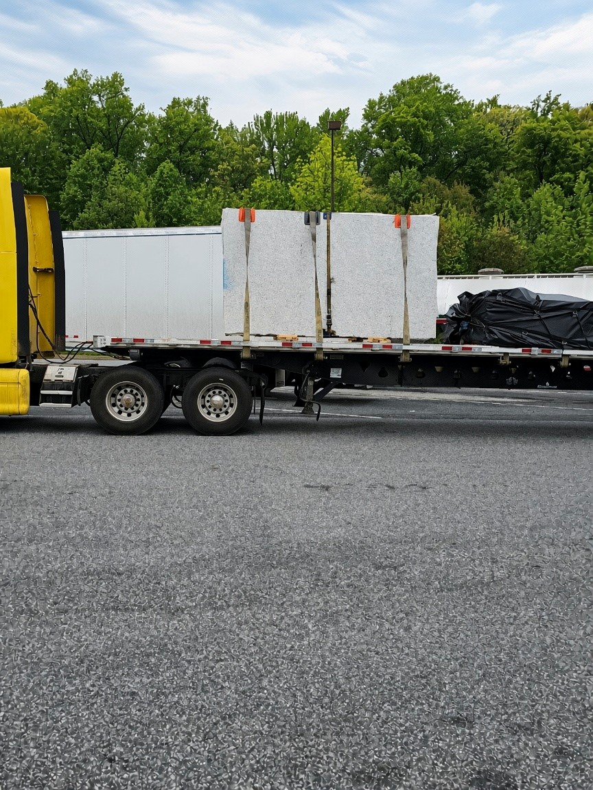 Tarped flatbed load locked for transit