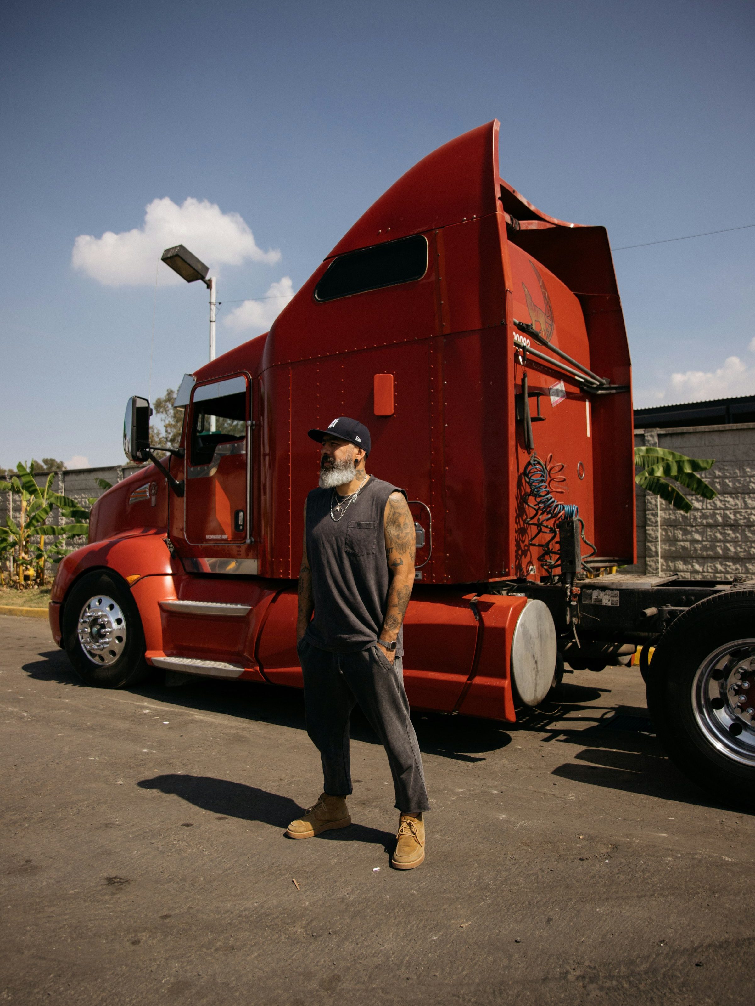 Truck driver next to a red semi truck